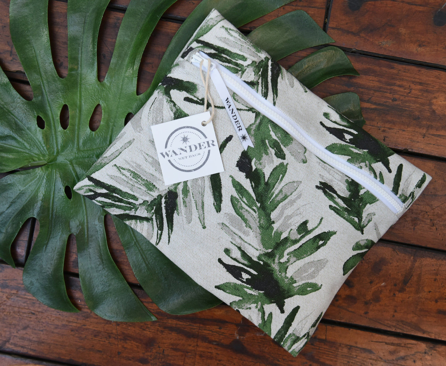 Stand Tall in Palm Frond Wet Bag | Wander Wet Bags, on a wood background